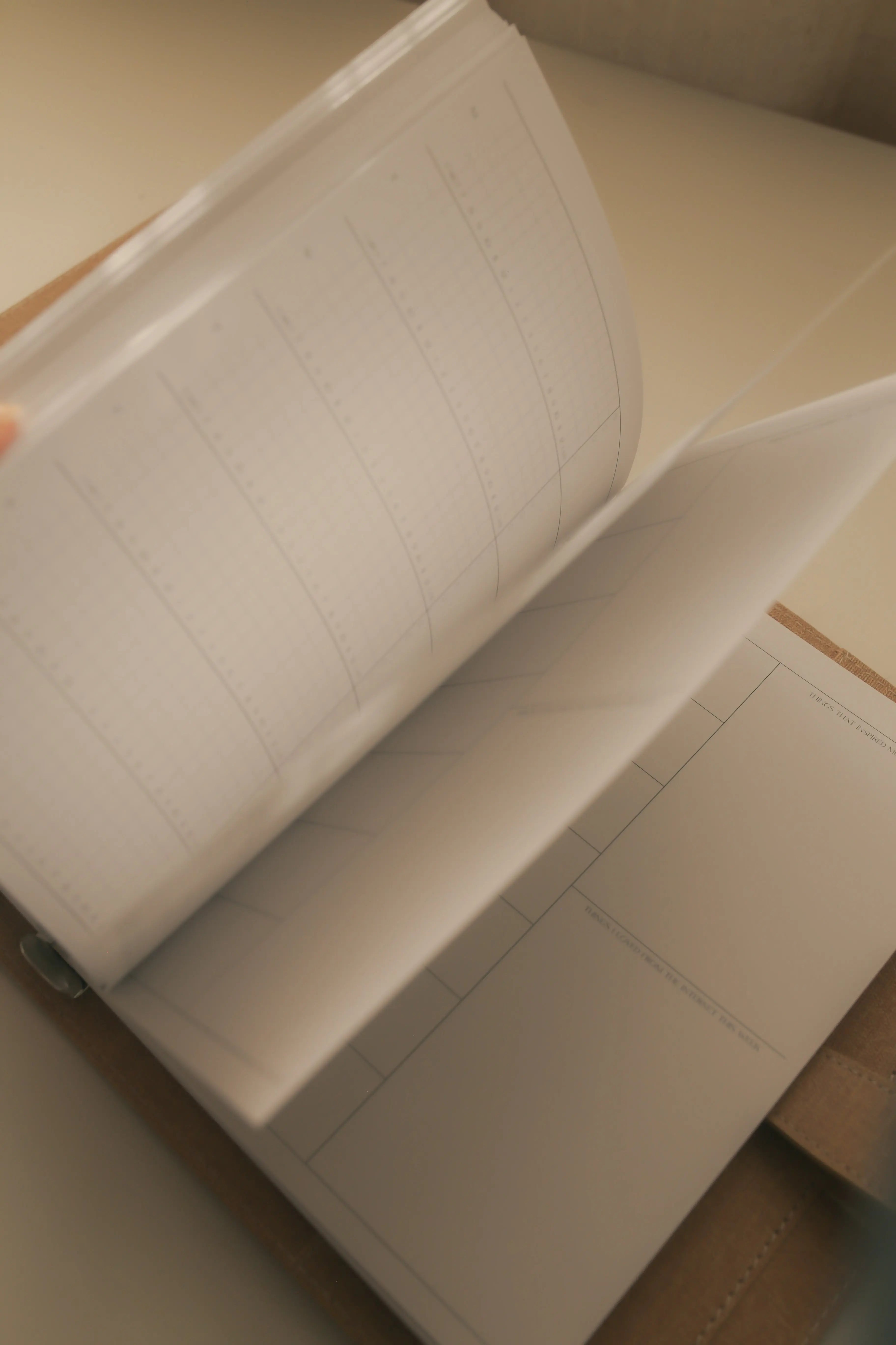 Open view of the With Love Archive planner with pages showing movement, highlighting the fluid and engaging design of the planner’s layout.